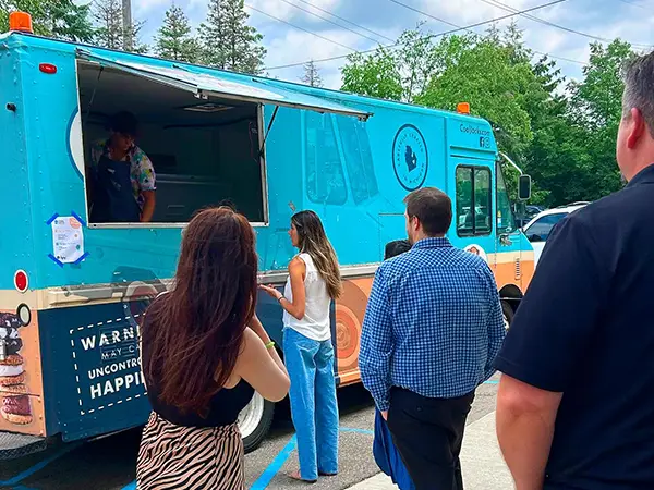 A CG Detroit wrapped vehicle at a public event
